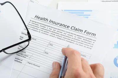 A person filling out an insurance claim form.